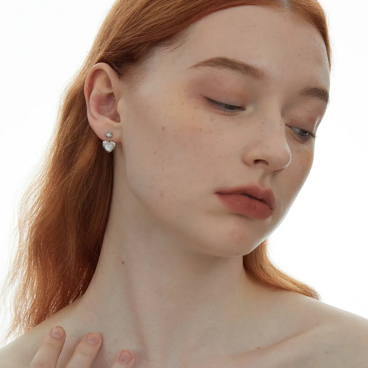 Pearl Heart Drop Earrings with Ornate Frame — front model portrait wearing the earrings