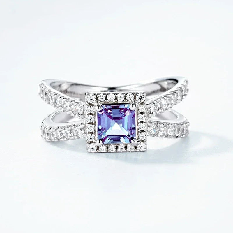 Princess-cut Alexandrite halo ring with a split shank, center stone close-up on a white background