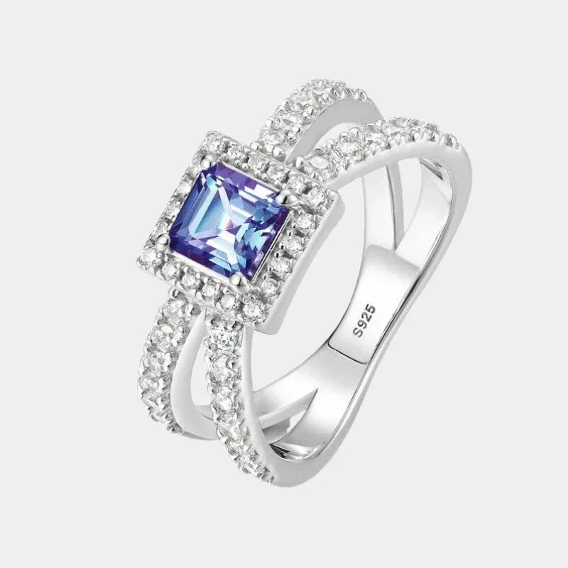 Princess-cut Alexandrite halo ring with a split shank, front product view on a white background
