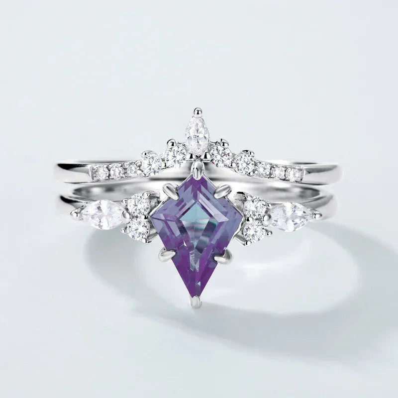 Princess-cut Alexandrite two-band ring with clear accents, center stone close-up on a white background