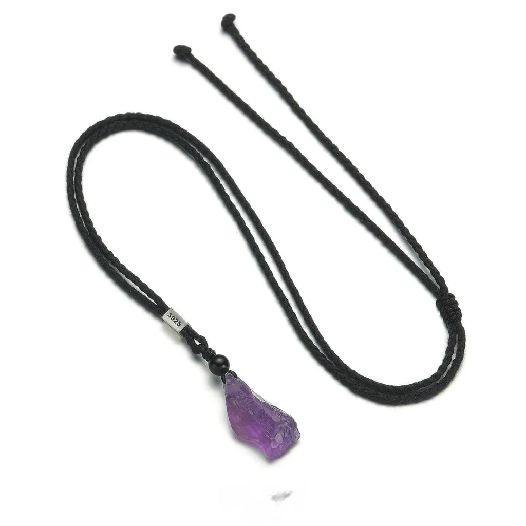 raw amethyst crystal cord necklace necklace laid flat on a white background