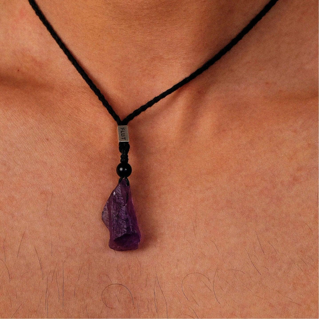 raw amethyst crystal cord necklace worn at the neckline in a close-up