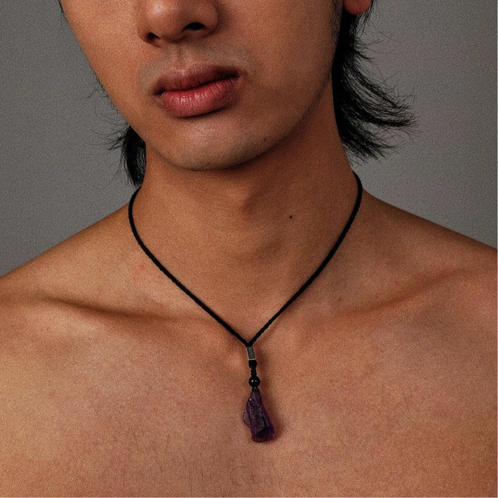 raw amethyst crystal cord necklace worn at the neckline in a portrait