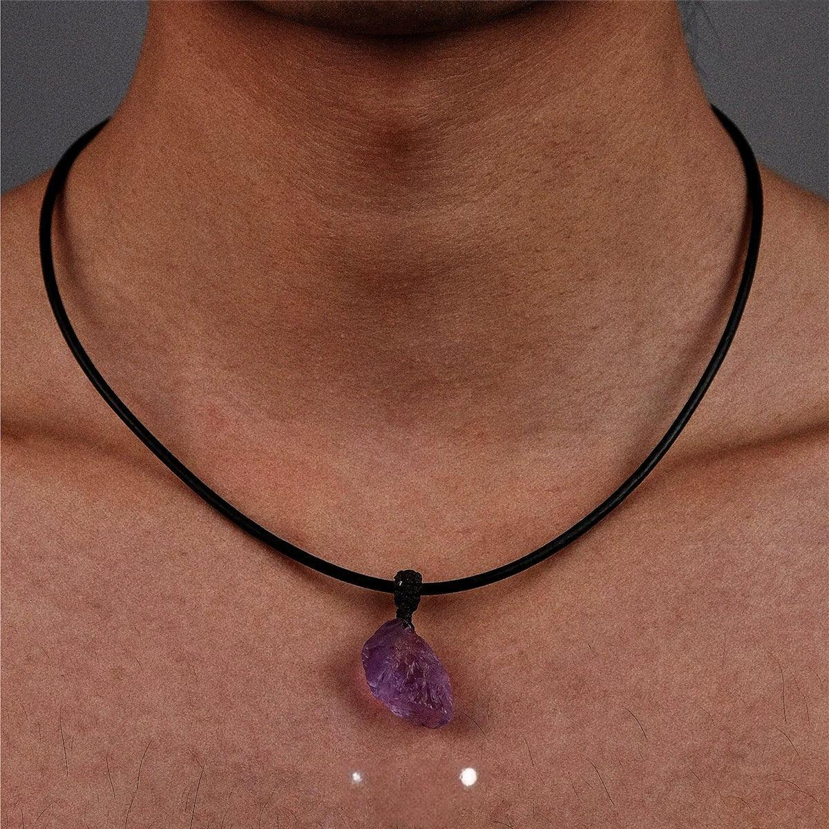 raw amethyst stone cord necklace worn at the neckline in a close-up