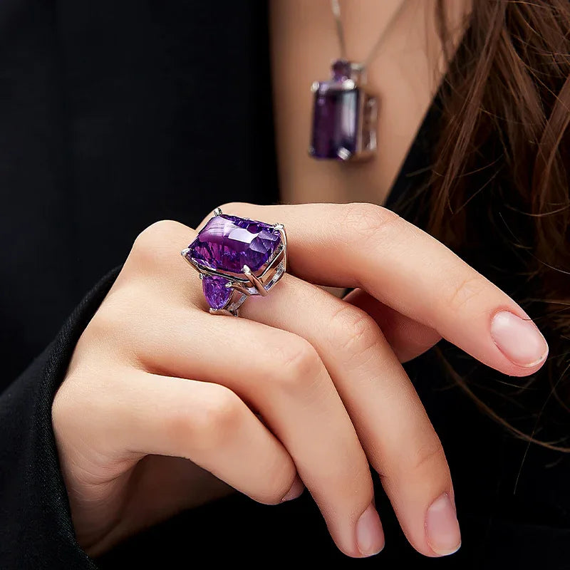rectangular amethyst accent ring worn on the hand from a second angle