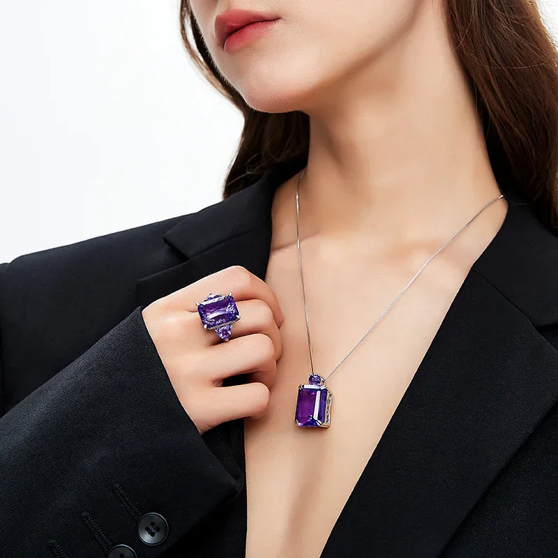 rectangular amethyst accent ring worn on the hand in a close-up