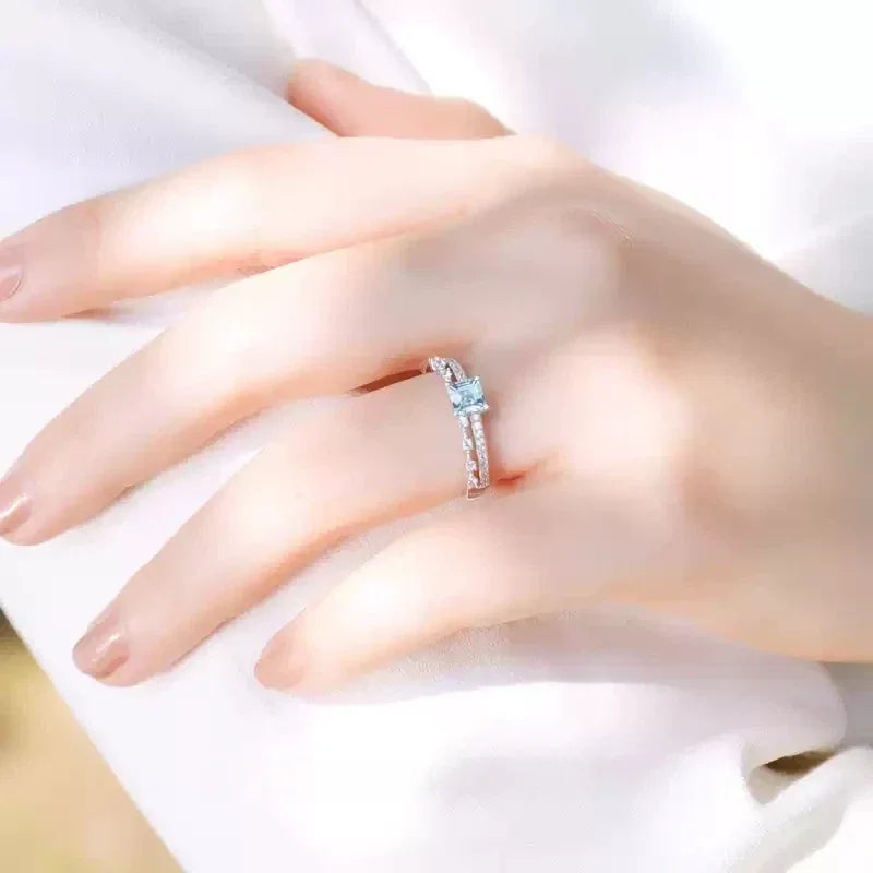 Rectangular Aquamarine Pave Band Ring worn on the hand in a close-up
