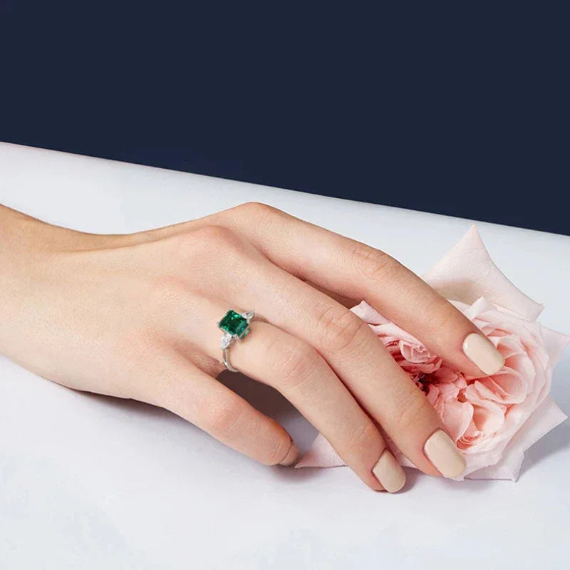 Rectangular Emerald Adjustable Ring worn on the hand in a close-up