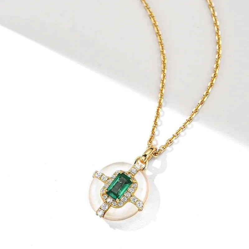 Rectangular Emerald Cross Pendant Necklace pendant and chain detail on white