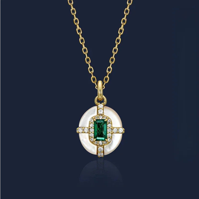 Rectangular Emerald Cross Pendant Necklace pendant view on a dark background