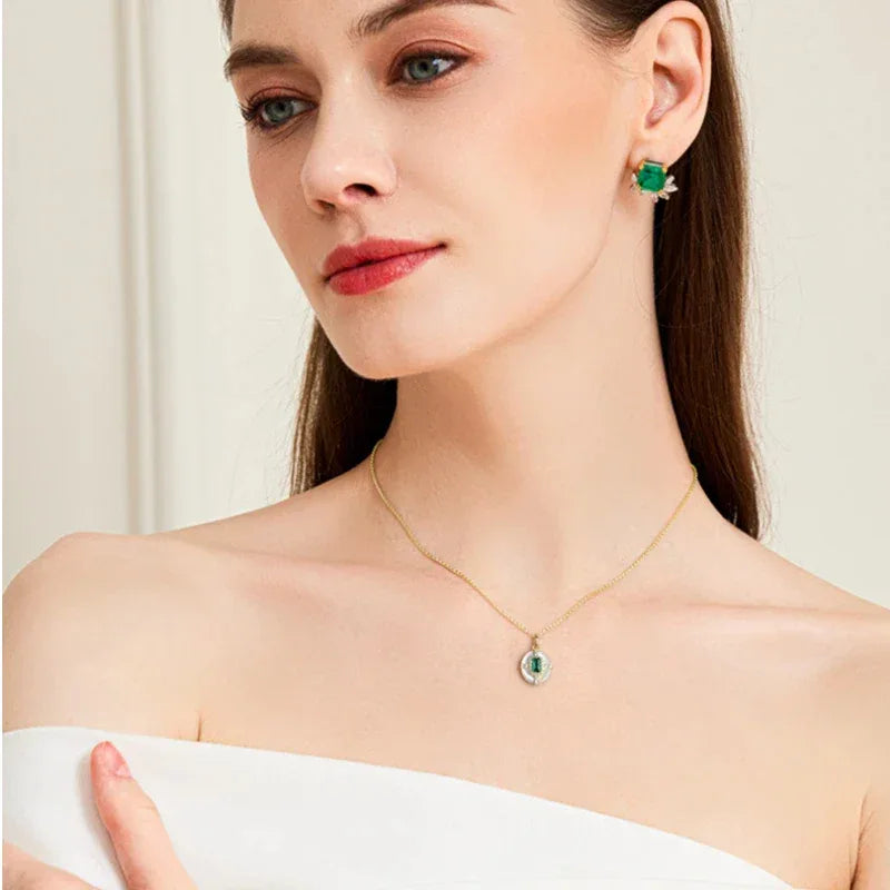 Rectangular Emerald Cross Pendant Necklace worn at the neckline from a second angle