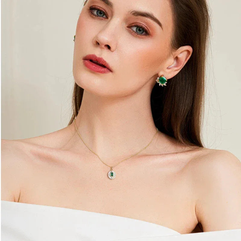 Rectangular Emerald Cross Pendant Necklace worn at the neckline in a close-up