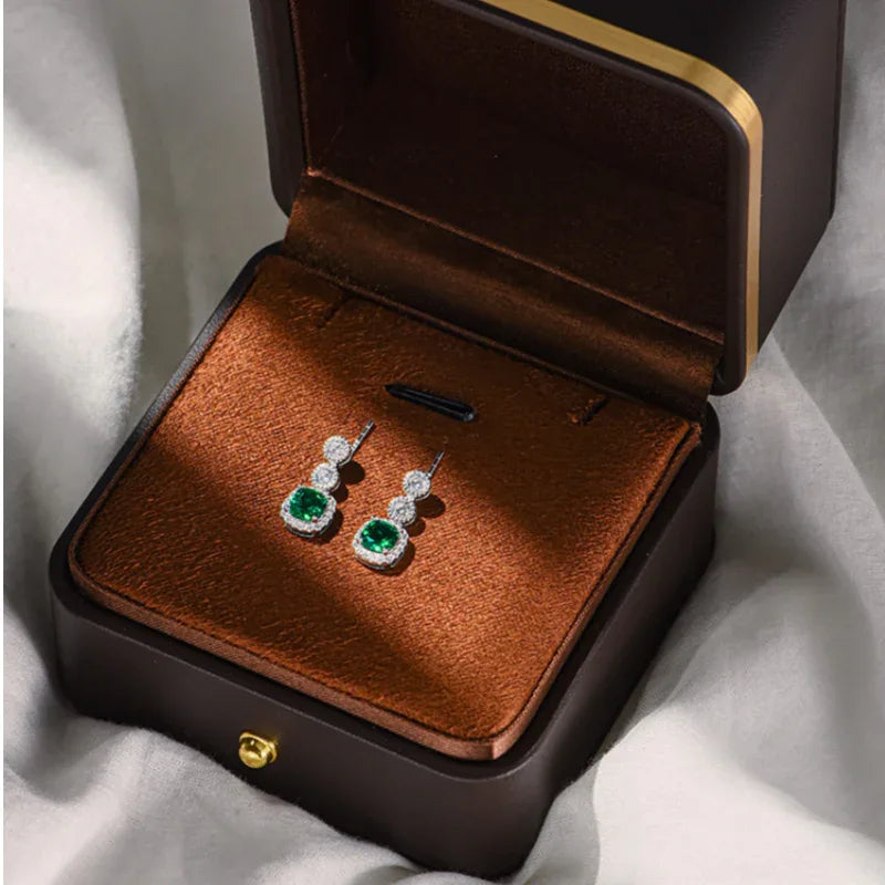 Rectangular Emerald Drop Earrings paired product view on a dark background