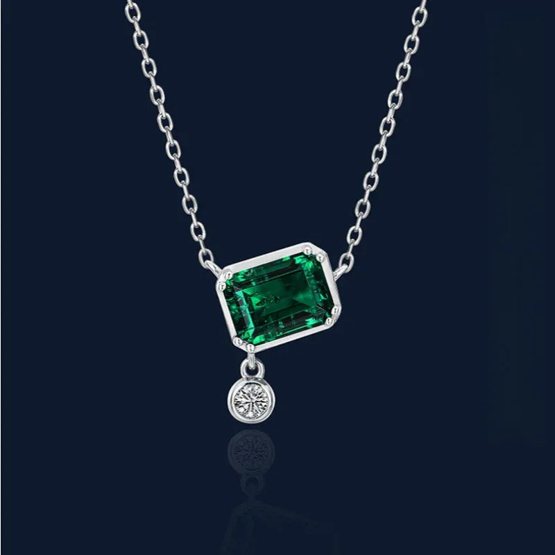 Rectangular Emerald Drop Pendant Necklace pendant view on a dark background