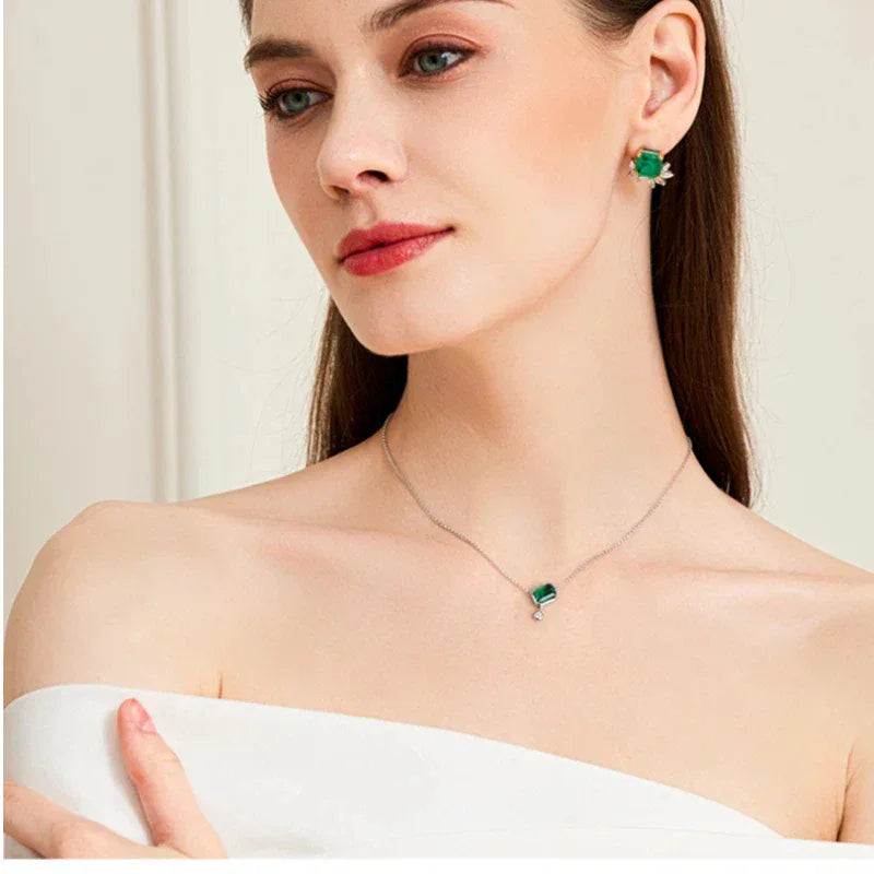 Rectangular Emerald Drop Pendant Necklace worn at the neckline in a close-up