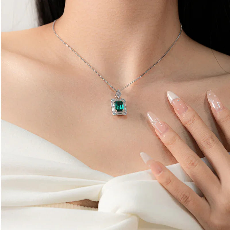 Rectangular Emerald Geometric Halo Necklace worn at the neckline in a close-up