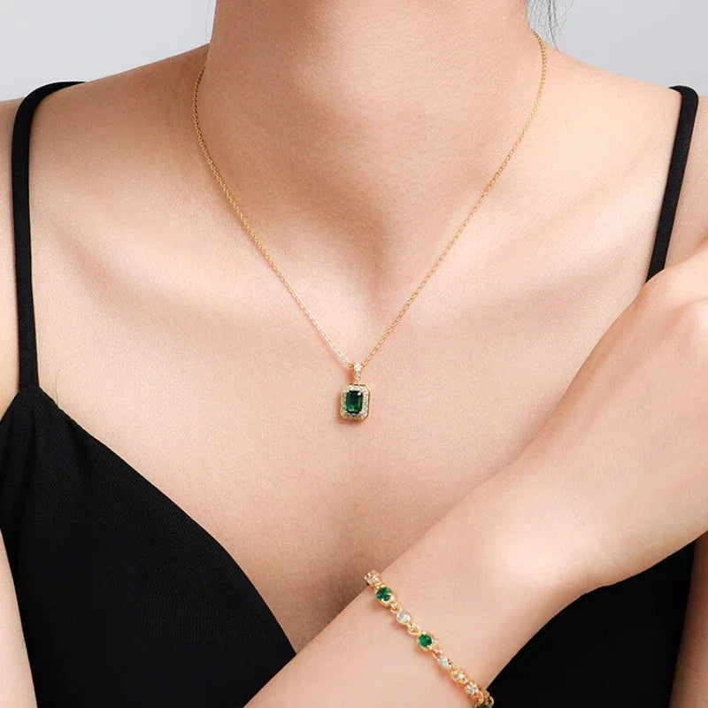 Rectangular Emerald Halo Pendant Necklace worn at the neckline in a close-up