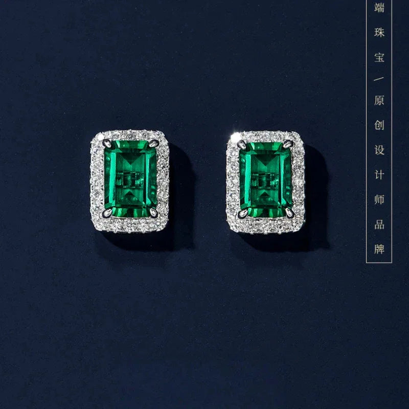 Rectangular Emerald Halo Stud Earrings paired product view on a dark background