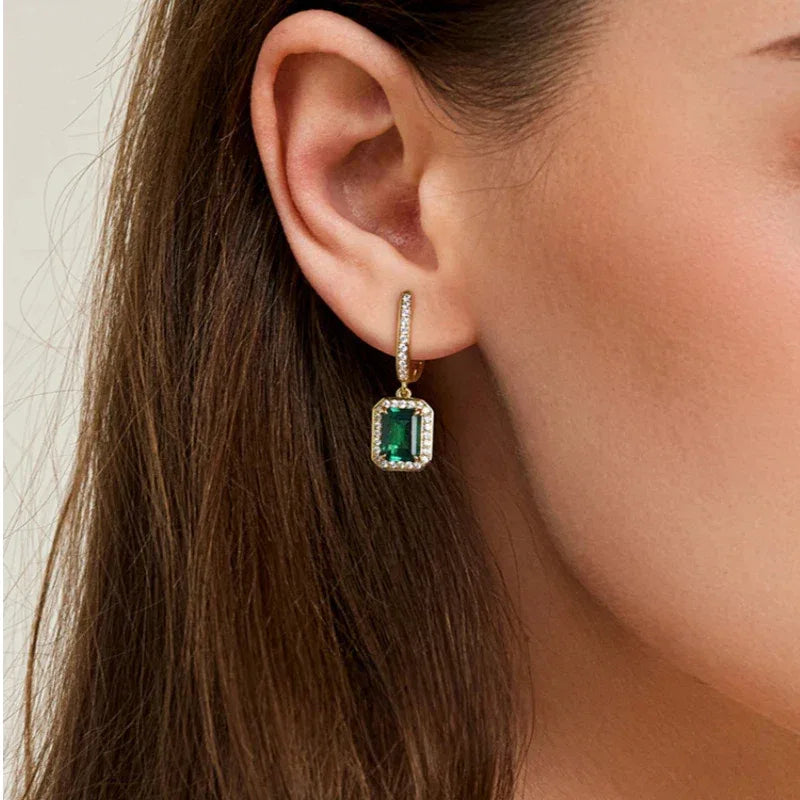 Rectangular Emerald Long Drop Earrings worn on the ear from a second angle