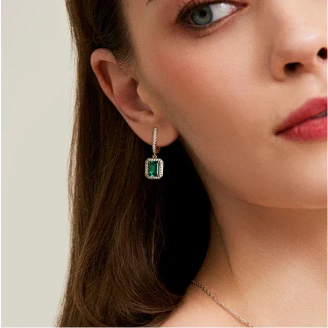 Rectangular Emerald Long Drop Earrings worn on the ear in a close-up