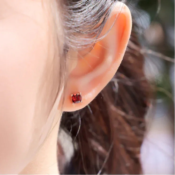 Rectangular Garnet Stud Earrings worn on the hand from a second angle