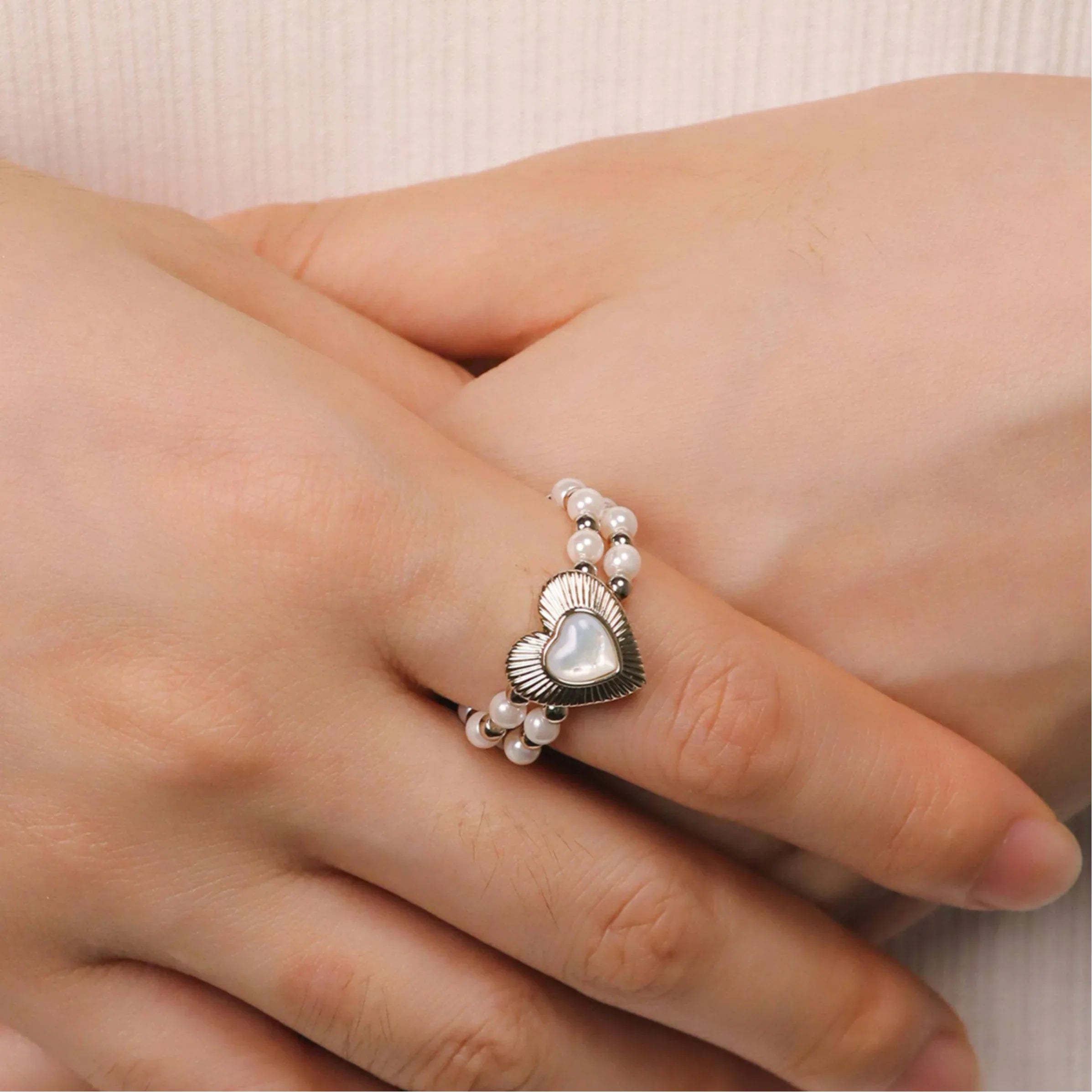 Triple-Row Pearl Heart Stretch Ring — hand-worn close-up showing the multi-row bead construction