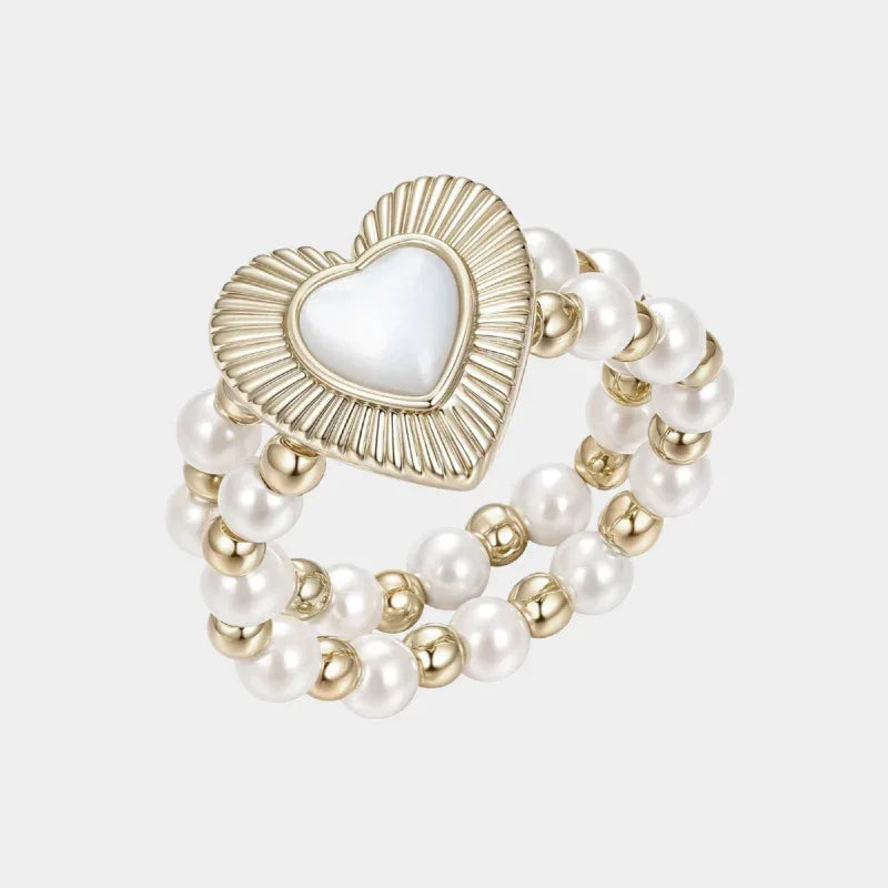 Triple-Row Pearl Heart Stretch Ring — isolated angled view of the triple-row pearl ring with a ridged heart