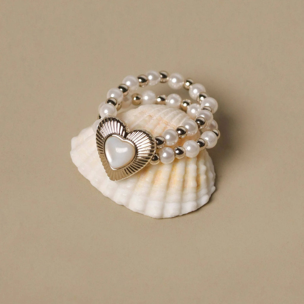 Triple-Row Pearl Heart Stretch Ring — angled display view showing the elastic bead rows
