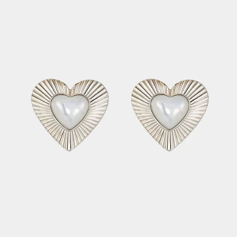 Ridged Pearl Heart Stud Earrings — front pair of ridged heart studs with pearl centers