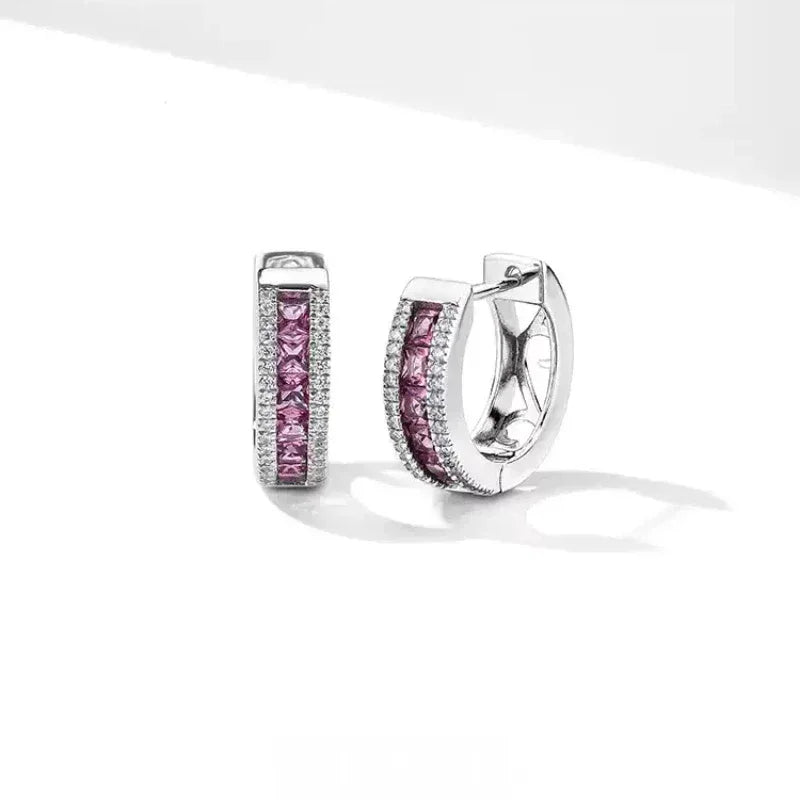 Rose-Purple Garnet Huggie Hoop Earrings side view held between the fingers