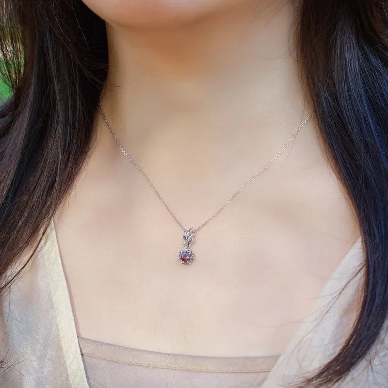 Round Alexandrite leaf drop necklace, shown worn in a close lifestyle view