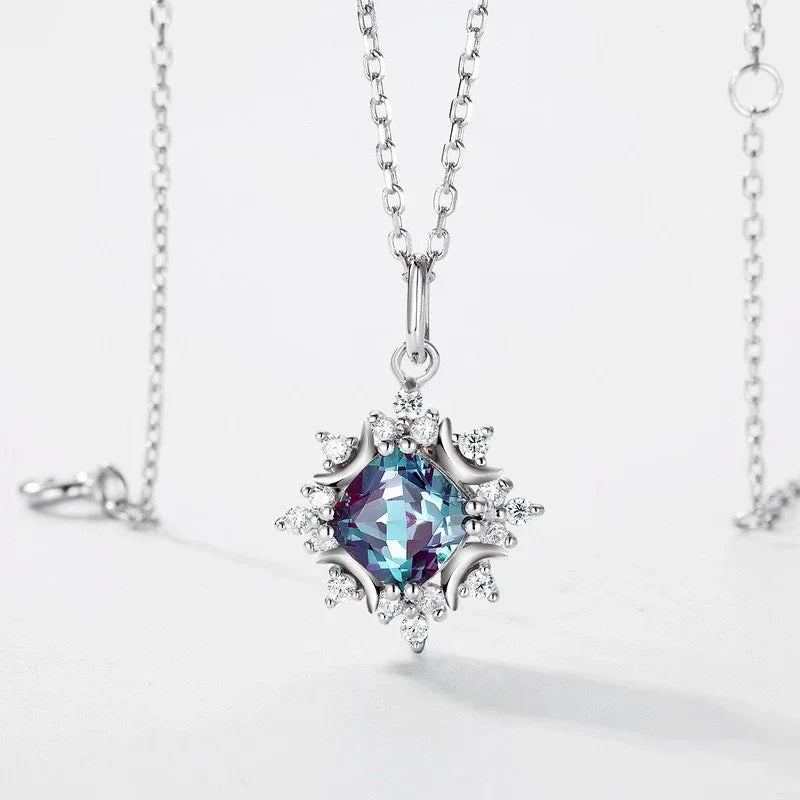 Round Alexandrite starburst pendant necklace, center stone close-up on a white background