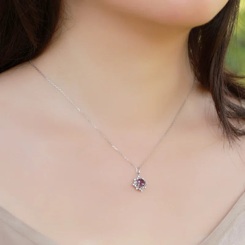 Round Alexandrite starburst pendant necklace, shown worn in a close lifestyle view