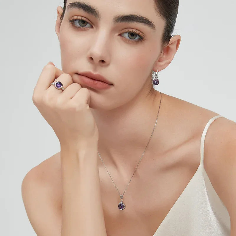 round amethyst bezel ring worn detail beside the face