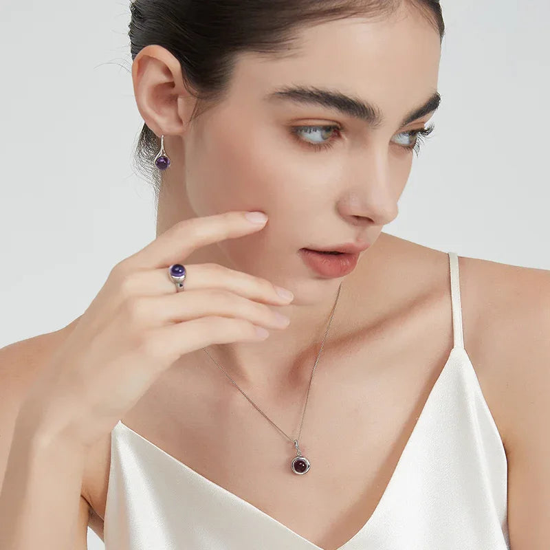round amethyst bezel ring worn on the hand from a second angle
