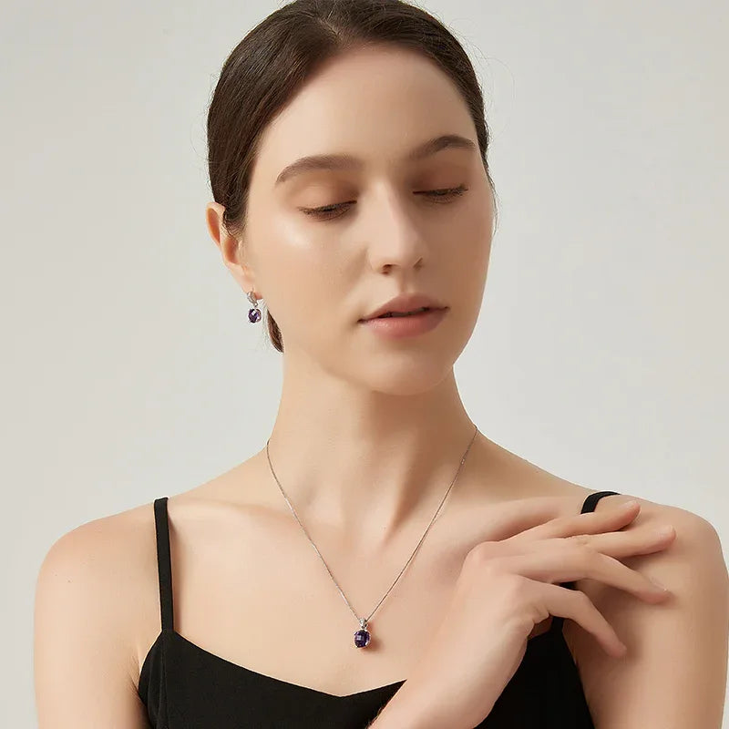 round amethyst drop earrings side portrait with the earrings