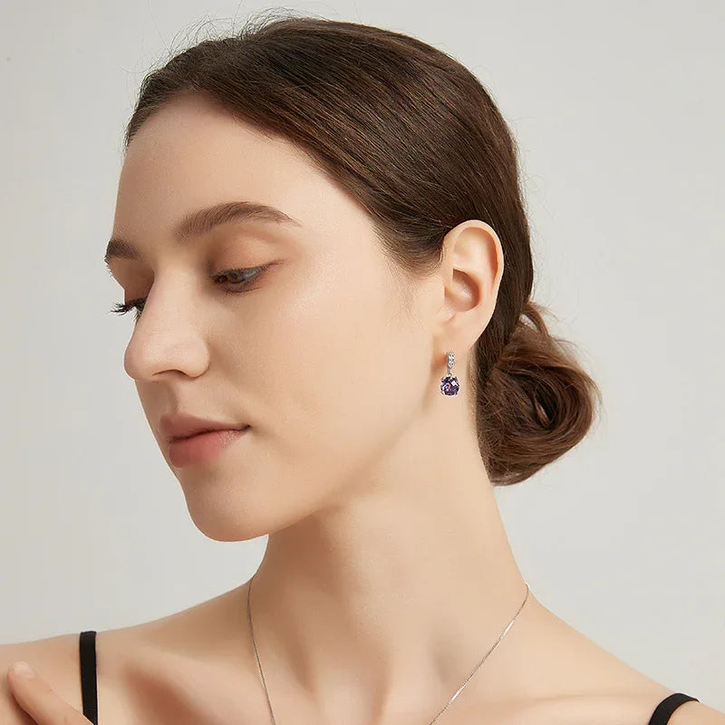 round amethyst drop earrings styled portrait showing the earrings for scale