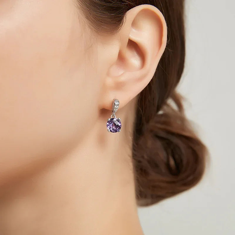 round amethyst drop earrings worn on the ear from a second angle