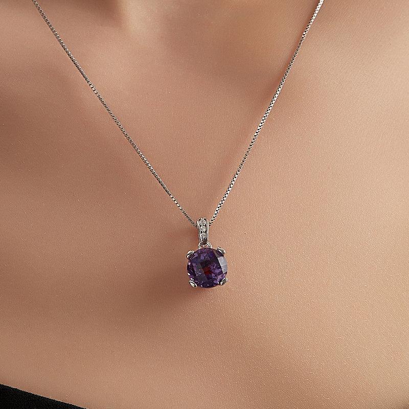 round amethyst pendant necklace worn at the neckline in a close-up