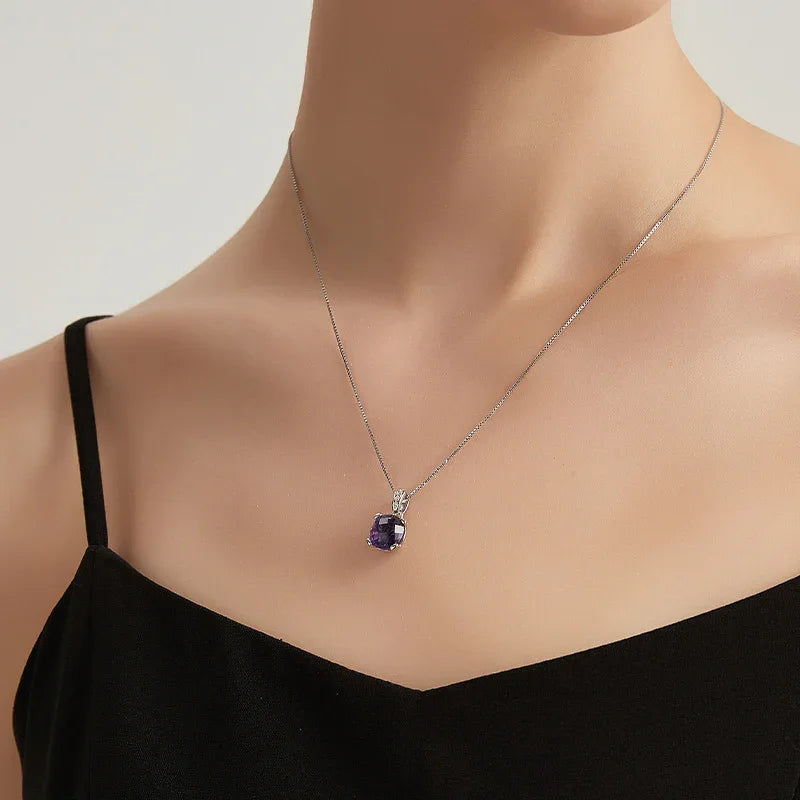 round amethyst pendant necklace worn at the neckline in a portrait