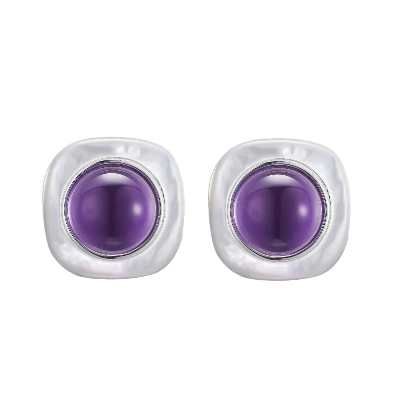 round amethyst stud earrings side portrait with the earrings