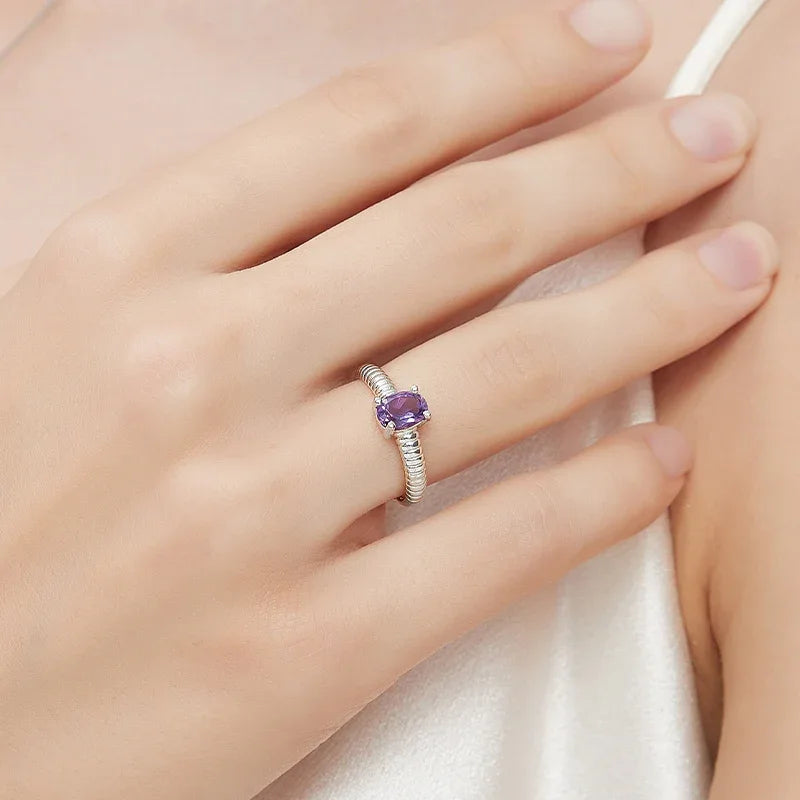 round amethyst open ring styled portrait showing the ring for scale