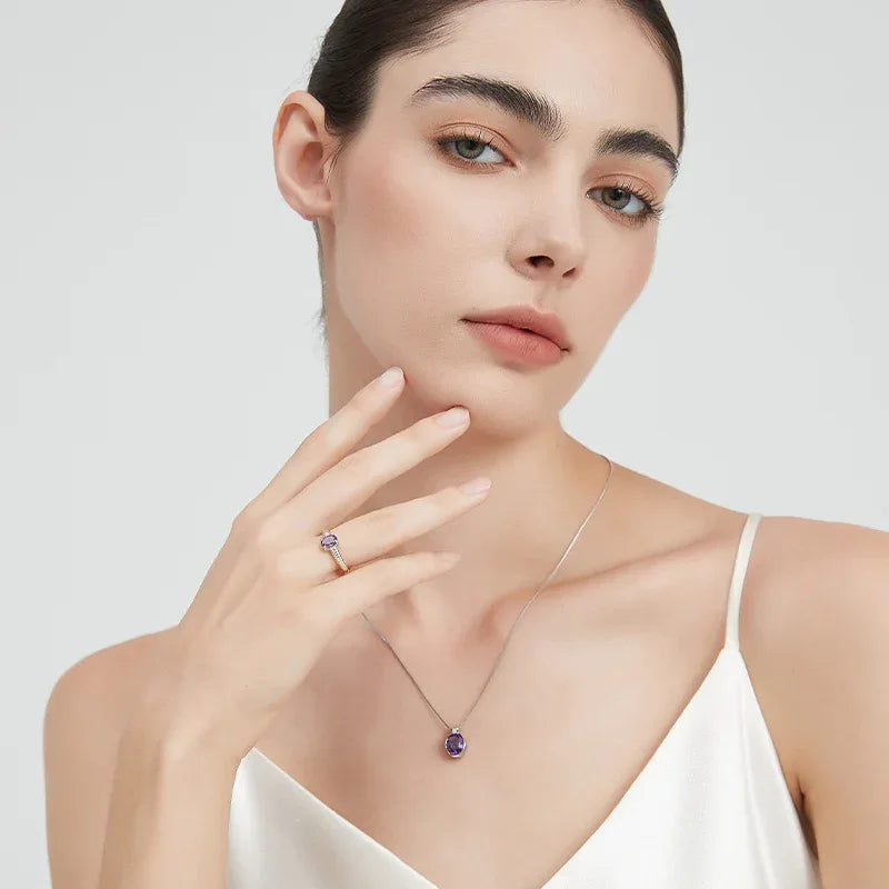 round amethyst open ring worn on the hand from a second angle