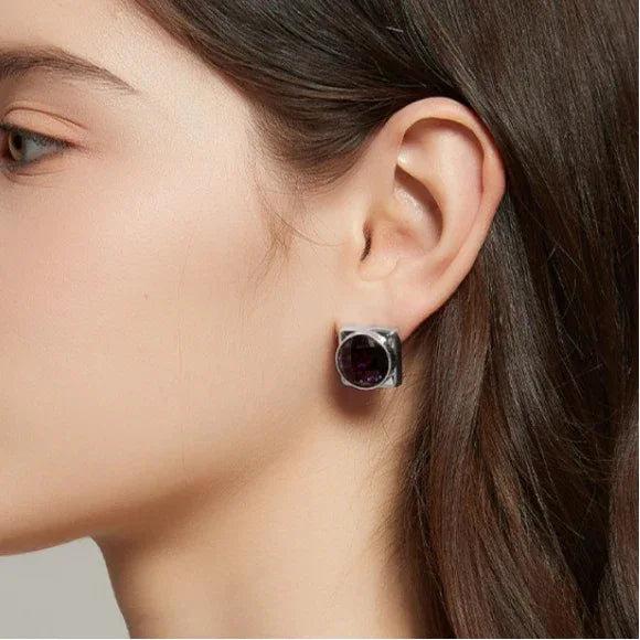 round amethyst stud earrings side portrait with the earrings