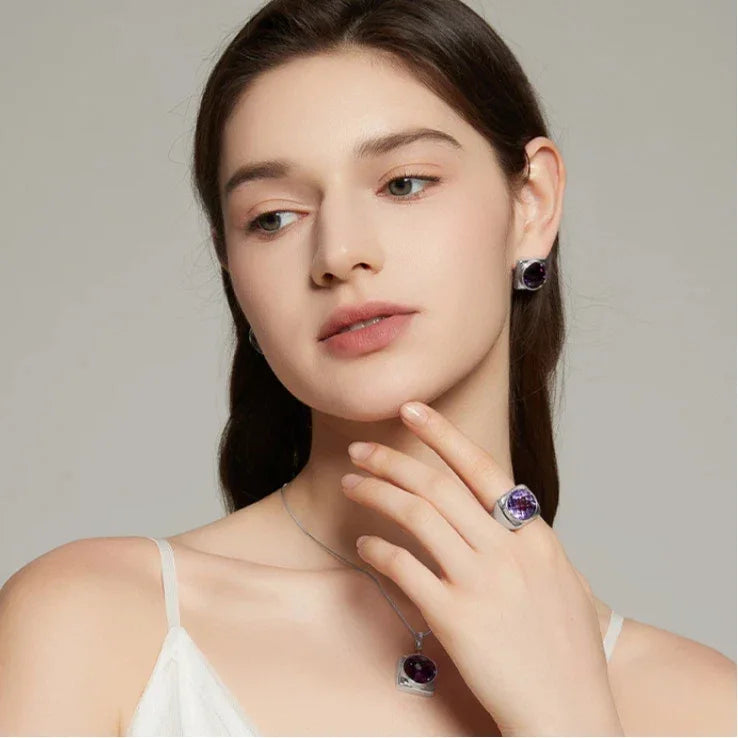 round amethyst stud earrings styled portrait showing the earrings for scale