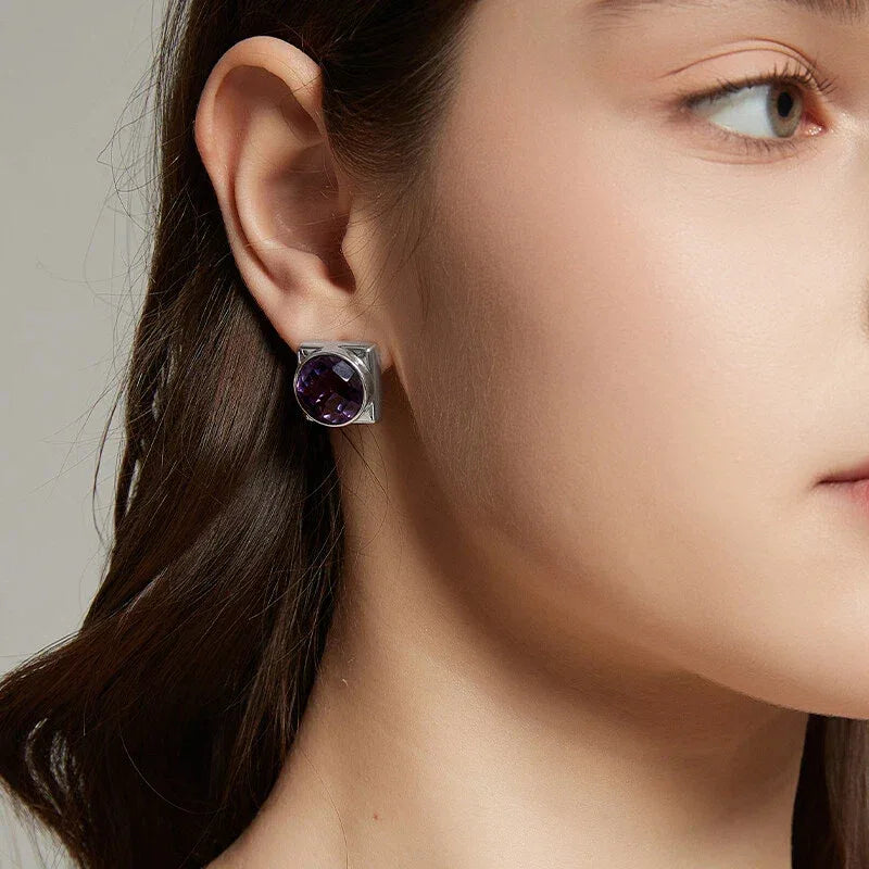 round amethyst stud earrings worn on the ear from a second angle