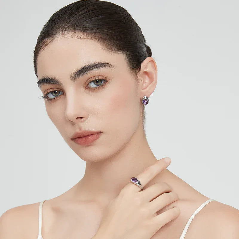 round amethyst stud earrings side portrait with the earrings
