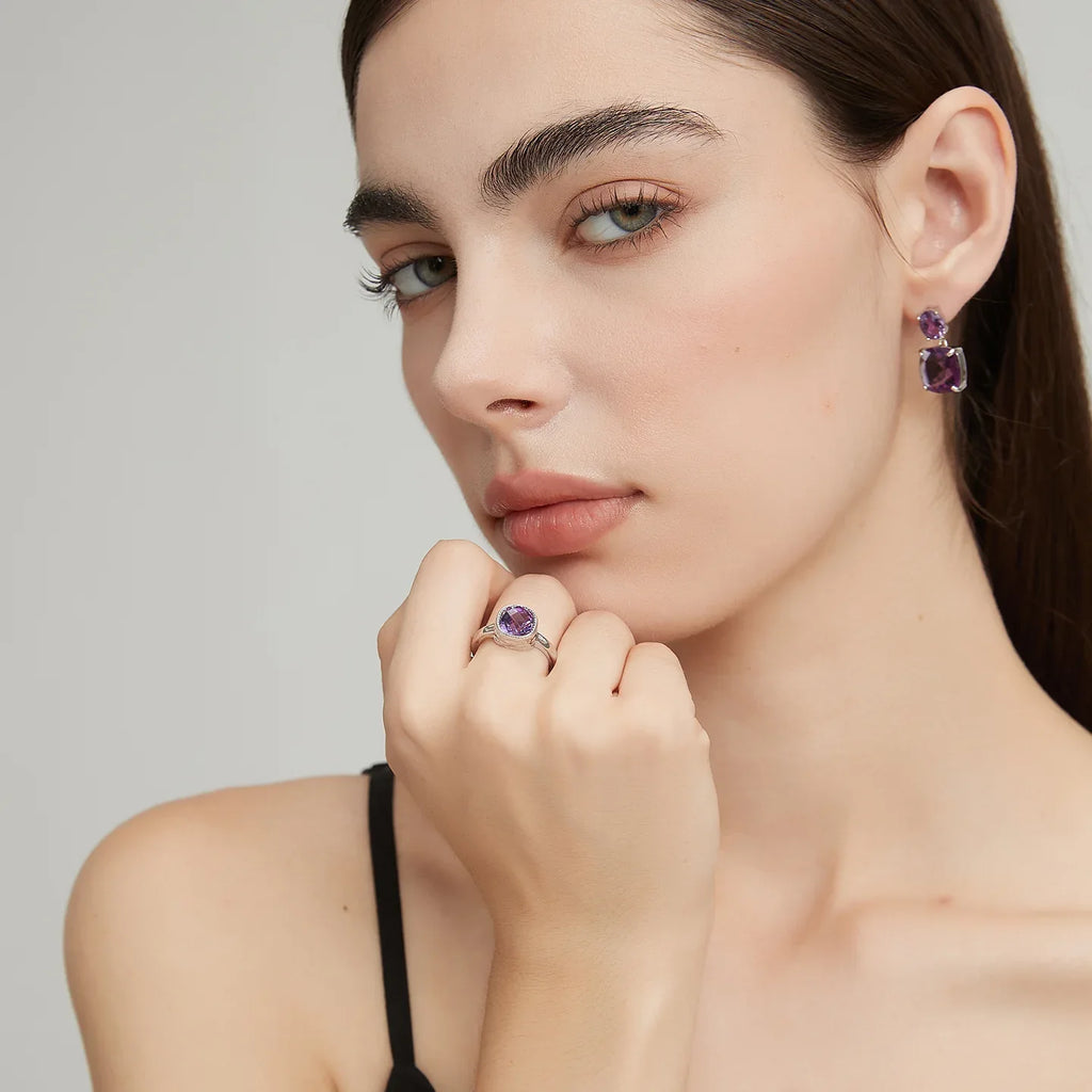 round amethyst halo ring worn detail beside the face
