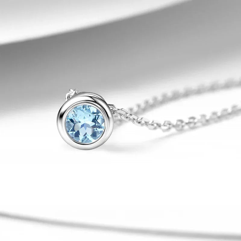 Round Aquamarine Bezel Pendant Necklace angled pendant detail on white