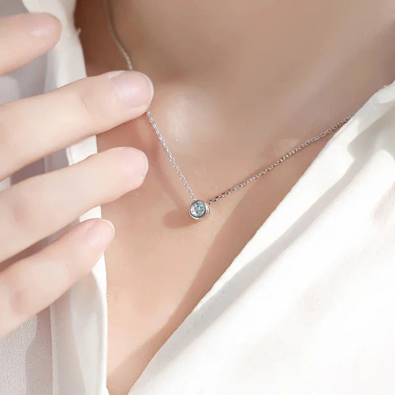 Round Aquamarine Bezel Pendant Necklace worn at the neckline from a second angle